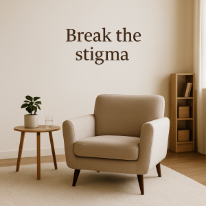 A quiet, sunlit counseling room with a modern armchair and simple decor. Text overlay reads “Break the stigma,” symbolizing a safe, welcoming space to challenge mental health misconceptions.